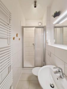爱尔福特Suite am Park的带淋浴和盥洗盆的白色浴室