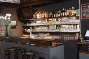 德布尔特布腾格迪富瑞时穆度假屋的酒吧设有酒吧凳和酒瓶