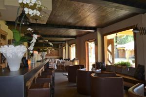 利维尼奥La Tresenda Hotel and Mountain Farm的餐厅设有酒吧,配有桌椅