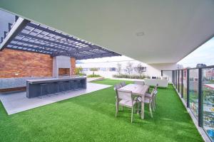 基多Moderna suite en Quito RG的户外庭院配有桌椅和草地。