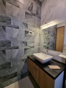 乌代浦Green Villa的一间带水槽和石墙的浴室
