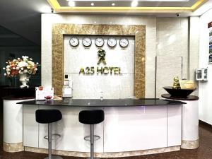 岘港A25 Hotel -137 Nguyễn Du - Đà Nẵng的一间餐厅,在房间内有一个带凳子的柜台