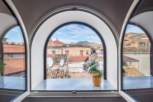 巴勒莫Open Sicily Homes "Residence Guascone" - Self check in的享有城市美景的拱形窗户
