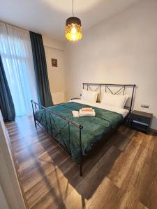 第比利斯Apartment in Tbilisi “Green Budapest “的一间卧室配有一张带绿色棉被的床