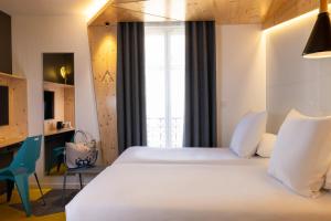 巴黎城市露营酒店的卧室配有一张白色大床和一张书桌