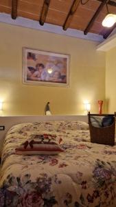 卡潘诺里La casa nella vigna [colline del vino]的一间卧室配有一张带花卉床罩的大床