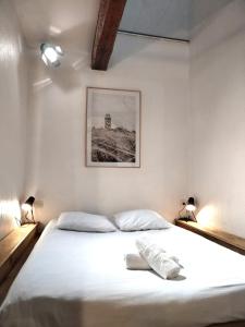 波城A Deux Pas des Halles - Hypercentre - Idéal Couple的一间卧室配有一张带两盏灯的大型白色床。