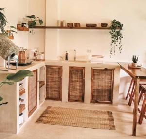 卢纳将军城Greenhouse Siargao Eco-Beach Resort的厨房设有木门、水槽和桌子