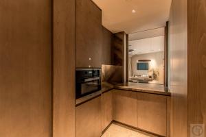 迪拜Super Spacious 3BR with Maid's Room in Five Palm的厨房配有木制橱柜和炉灶。