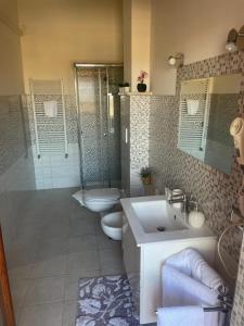 阿普里利亚OLEANDRI SUITE B&B的一间带两个卫生间、淋浴和盥洗盆的浴室