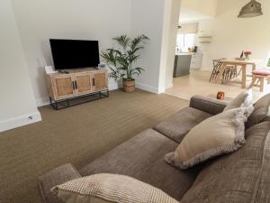 WoodfordShannon Vale的带沙发和平面电视的客厅