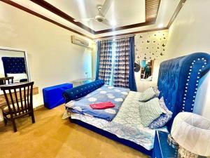 伊斯兰堡Family Apartment No 2 ISB F-11的一间卧室配有一张蓝色的床和一张桌子
