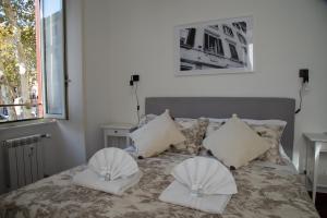 罗马Piazza Testaccio Home appartamento E 1 accogliente con vista piazza Testaccio的一间卧室配有一张带两个枕头的床