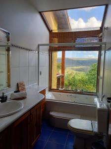 戈亚斯州上帕莱索Le Jardim的浴室设有窗户、水槽和卫生间。