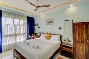 瓦斯科达伽马Premium 2BHK apartment with Pool Access的一间卧室设有一张大床和一个窗户。
