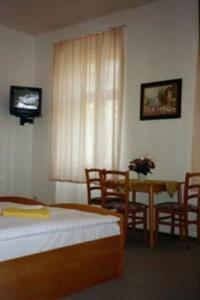 柏林佩西恩婚礼酒店的卧室配有一张床和一张桌子及椅子