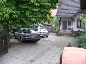 施瓦瑙祖尔索纳温特恩维尔潘森酒店的两辆汽车停在房子前面
