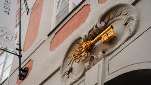 布拉格Hotel Golden Key Prague Castle的建筑物一侧的金色物体