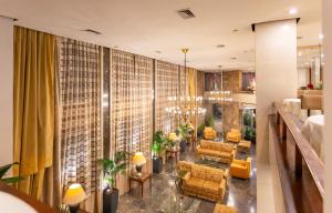 雅典Ilisia Hotel Athens的酒店大堂设有黄色的椅子和桌子