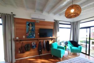 德尔迪阿布罗角Las Rochas, Suites de Mar的客厅配有蓝色椅子和电视