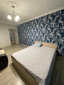 PrigorodnyyHouse near airport ЖК ЮГ的一间卧室配有蓝色和白色壁纸的床