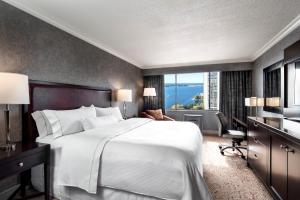多伦多多伦多港口城堡威斯汀酒店的卧室配有一张白色大床和一张书桌