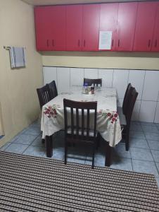 苏瓦Mishra Residence的一张桌子,配有四把椅子和粉红色的橱柜