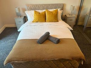 HooApartment in Central Gillingham的一间卧室配有一张带黄色枕头的大床