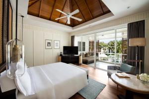 华欣InterContinental Hua Hin Resort, an IHG Hotel的一间带白色大床的卧室和一间客厅