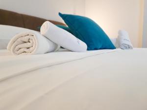 巴尼亚卢卡Hotel Wellness&Spa Astorya Banja Luka的一张带毛巾和枕头的床