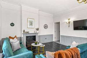 伦敦LiveStay - London Chiswick Apartments with Free Parking的客厅配有蓝色的沙发和电视
