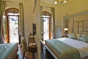 王子岛群No2 Hotel By Şükrü的卧室配有一张床、一张书桌和窗户。