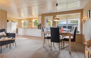 埃贝尔托夫特Amazing Home In Ebeltoft With Wifi的厨房以及带桌椅的用餐室。