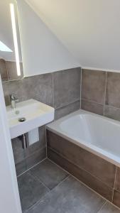 杜伊斯堡Deluxe Loftapartement Big Size的浴室配有白色浴缸和水槽