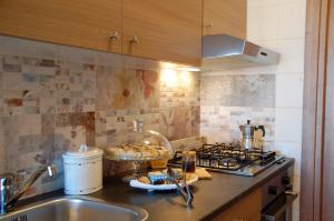 特拉尼DIMORE DEL SUD City Center的厨房柜台设有水槽和炉灶。
