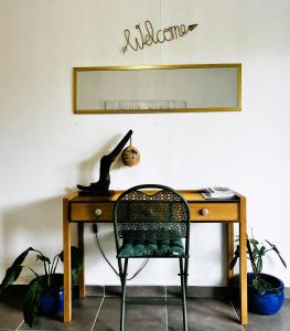 MatouryLa Villa Louisia的一张带椅子和镜子的桌子
