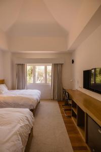 阿雷基帕La Posada del Puente的酒店客房设有两张床和一台平面电视。