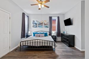 圣路易斯Exquisitely Designed Townhome - JZ Vacation Rentals的一间卧室配有一张床和吊扇