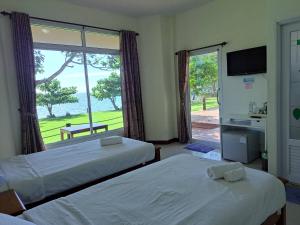 Ban Bang Pit Lang洛塔雷特拉特度假酒店的一间卧室设有两张床和大窗户