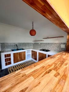 卡塔赫纳Colonial Beach Airport Hotel的厨房铺有木地板,配有木台面。