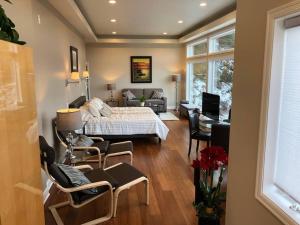 西雅图Romantic Spacious Suite with Salish Sea & Mountain Views at Seattle Luxury Estate的一间卧室设有一张床和一间客厅。