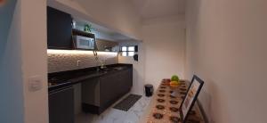维多利亚Apartamento Mania Terceiro Andar的一间带水槽和微波炉的小厨房