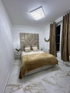 德勒Golden House的一间白色客房内配有一张大床的卧室