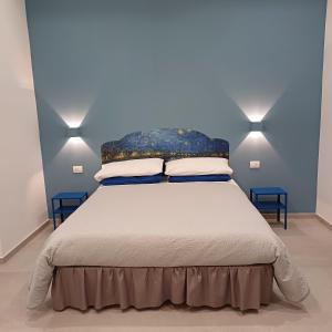 那不勒斯Partenope 10的一间卧室配有一张带两面蓝色墙壁的床