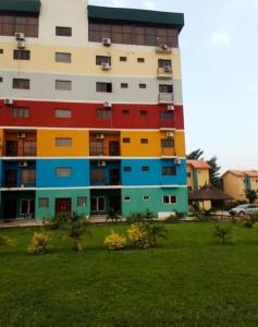 伊巴丹Ibadan Serviced Apartments的公园里一座有五颜六色门窗的建筑