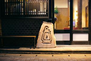 壹岐市LAMP Iki的坐在建筑物前面人行道上的标志