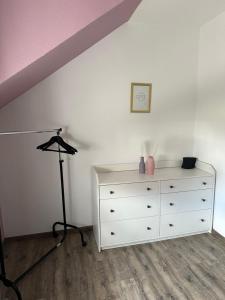 梅德巴赫Ferienwohnung Umme' Ecke的卧室配有白色梳妆台和紫色天花板