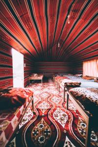 瓦迪拉姆哈立德营地酒店的红色天花板的客房内设有两张床。