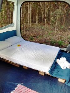 大塞拉YbYmara Eco Glamping的一张位于野营车后面的床位,带窗户