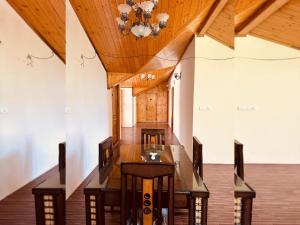 西姆拉Divine Hills Mashobra的一间带长桌和吊灯的用餐室